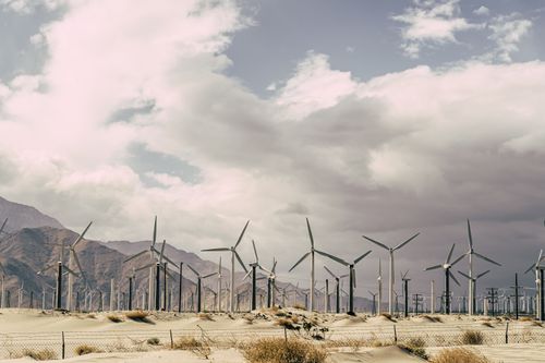 Free Wind turbines against dramatic desert landscape, promoting sustainable energy solutions. Stock Photo