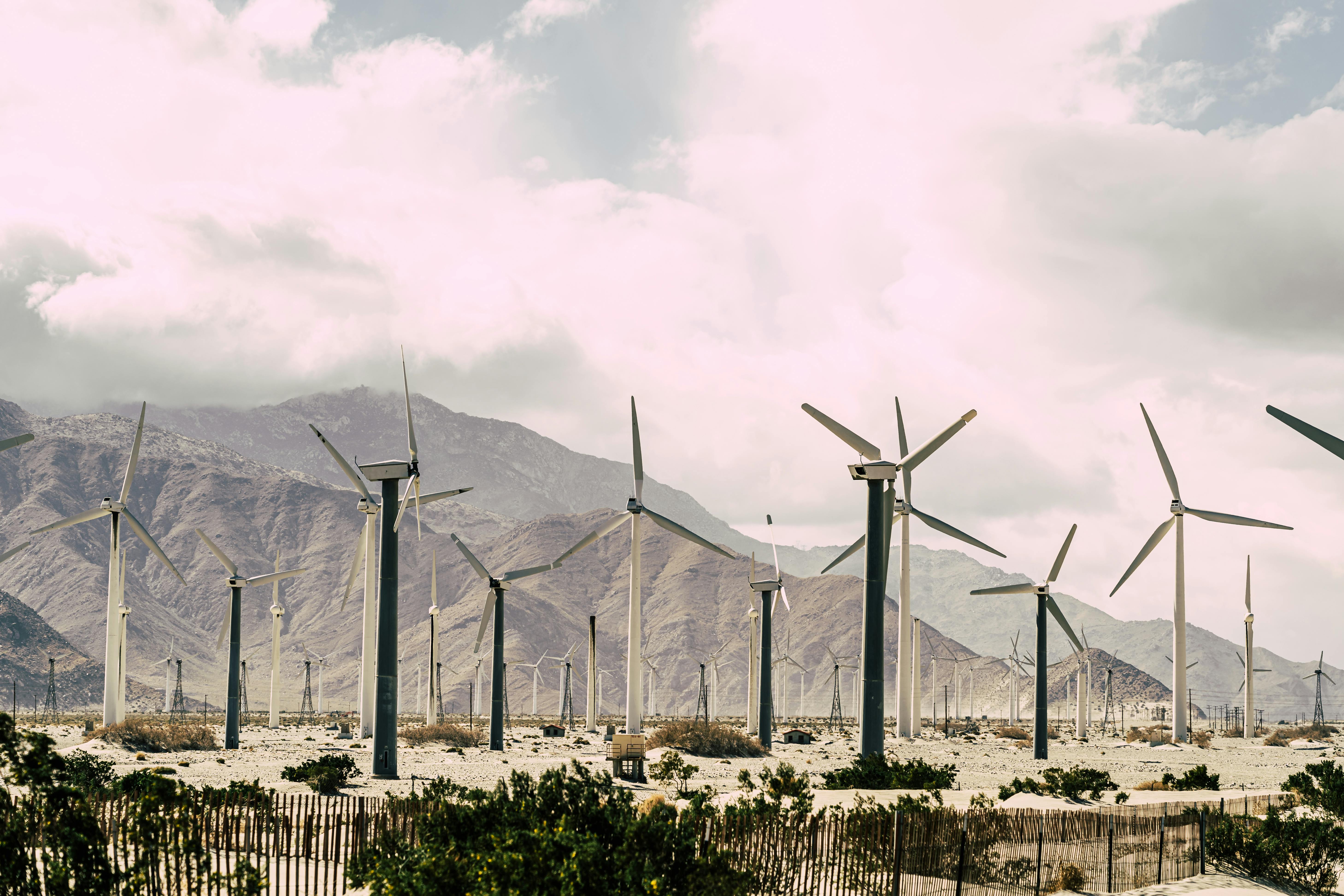 wind turbines under white cloudy sky