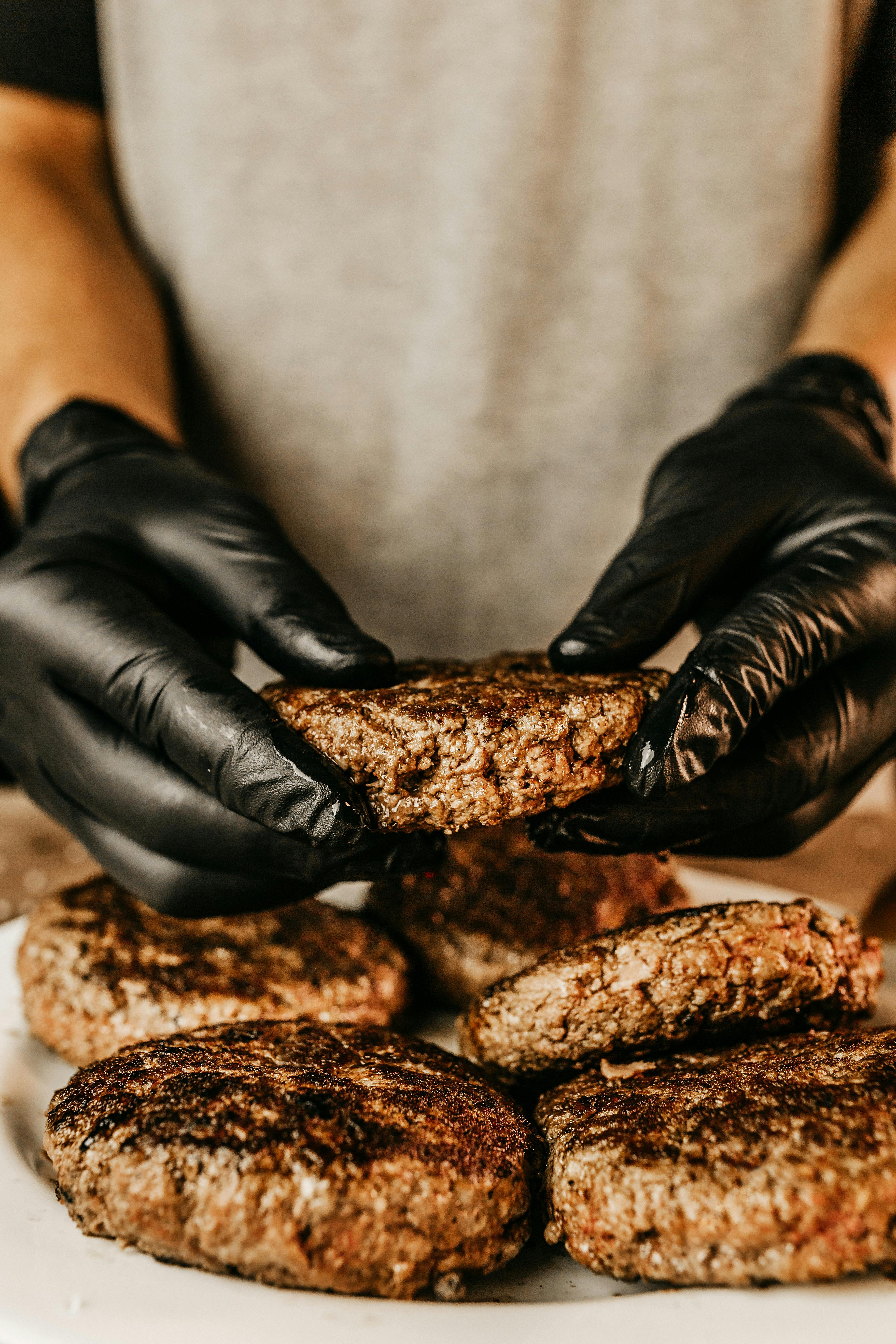 Person Wearing Gloves Holding Beef Patty · Free Stock Photo