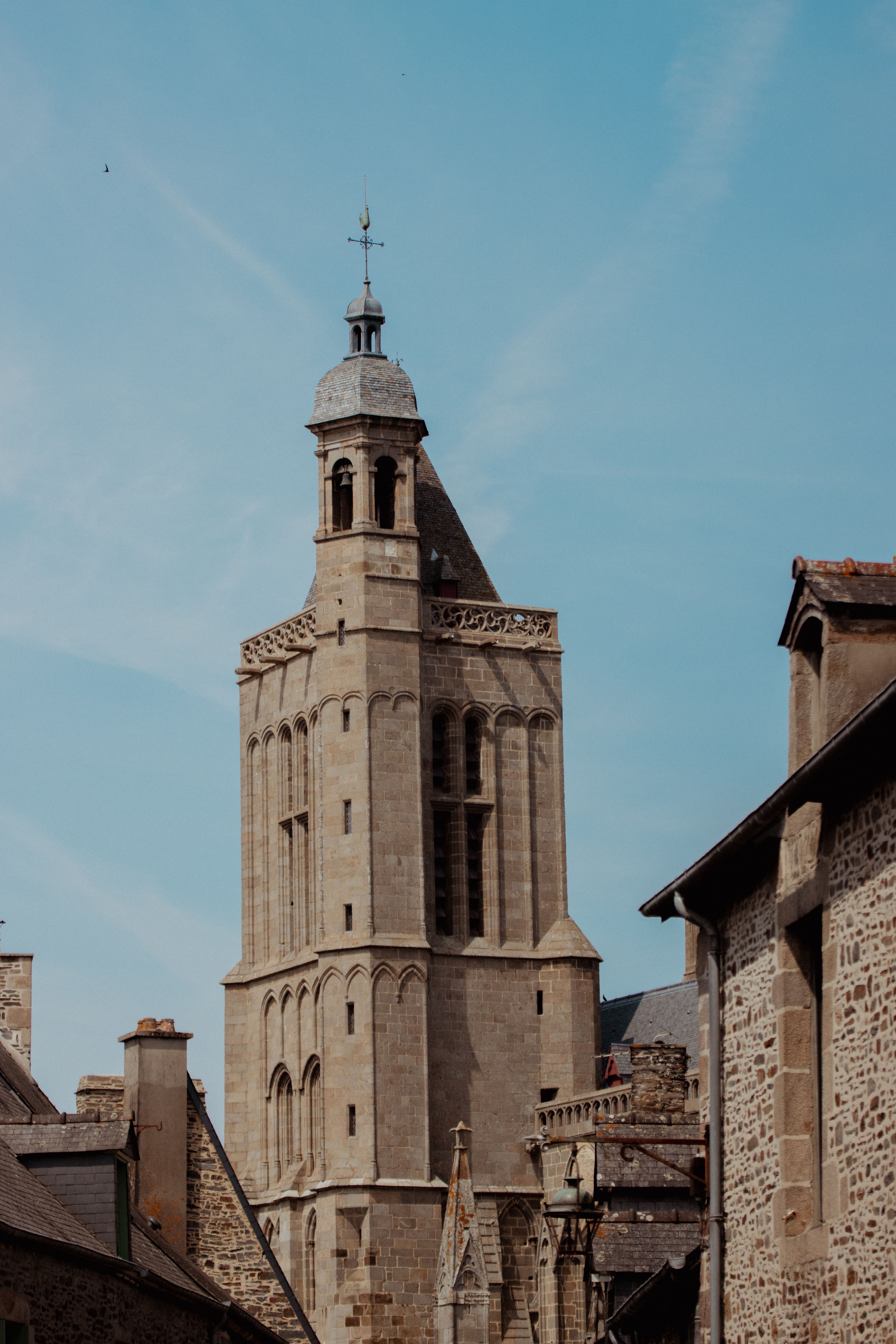 Historic medieval tower in Dol-de-Bretagne under a clear blue sky.