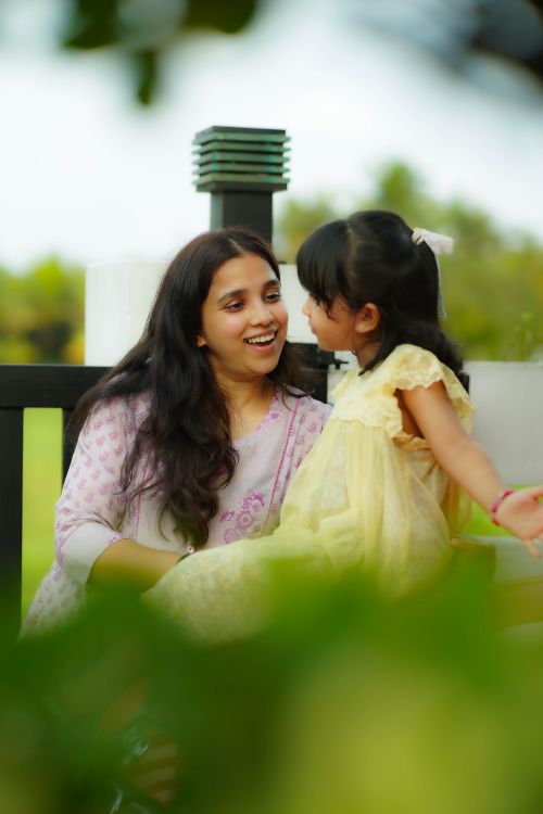 Free A loving mother and her young daughter enjoy a happy moment together outdoors on a sunny day. Stock Photo