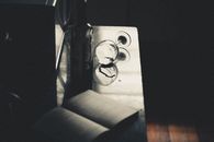 Fallen wine glass near open book in kitchen at home
