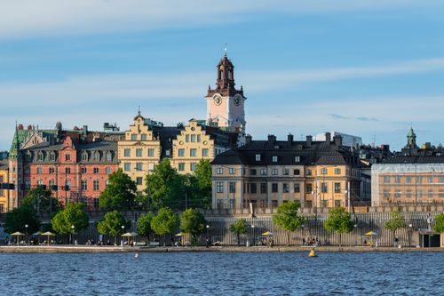 Free Charming view of colorful historic buildings along Stockholm's waterfront on a sunny day. Stock Photo