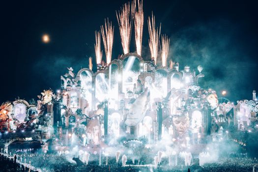 Dazzling fireworks light up Tomorrowland's grand stage in Boom, Belgium, at night.