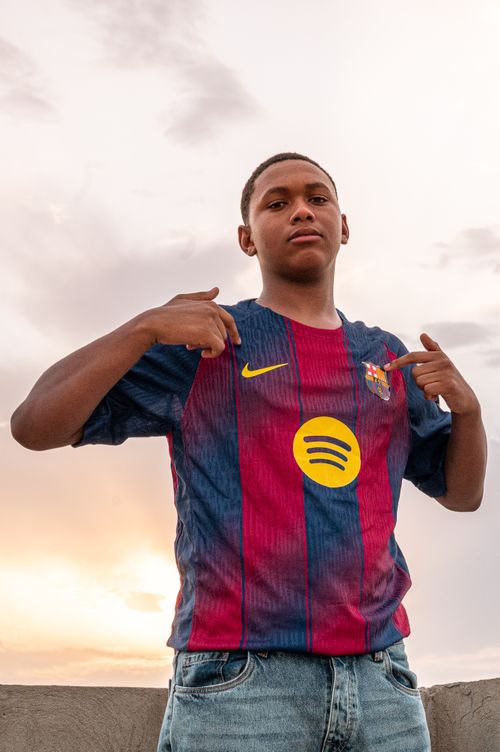 Free Teenager posing confidently in sports jersey outdoors, showcasing team pride. Stock Photo
