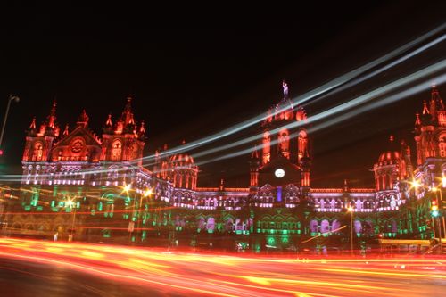 Free Illuminated Chhatrapati Shivaji Terminus at night with light trails creating a dynamic scene. Stock Photo