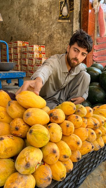 Young man selling fresh mangoes at a fruit stall in Mingora, Pakistan. - Understanding Product Quality Indicators for Dry Fruits