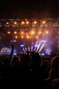 Night concert with bright stage lights, photo by Vizi Kata on Pexels