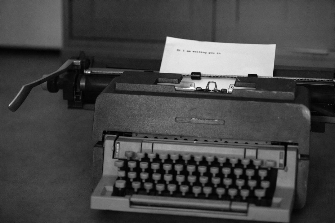 A classic typewriter with a paper displaying a typed message, captured in a vintage style.