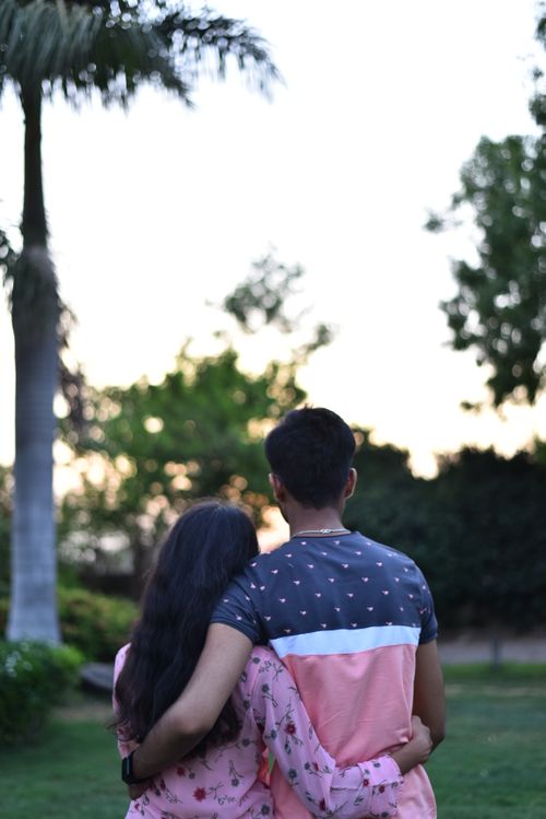 Free A couple embracing in a peaceful garden setting at sunset in Dhari, Gujarat. Stock Photo