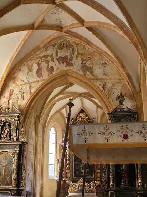 Free Historic Gothic church interior with frescoes and ornate altar view. Stock Photo