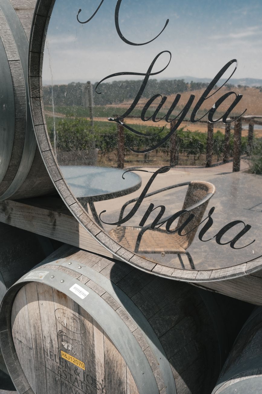 Rows of old barrels in a winery, a reminder that serious wine is built on boring, expensive patience.