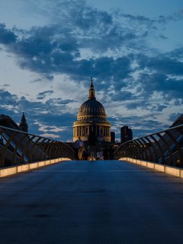 Dramatic twilight view of St. Paul's Cathedral from Millennium Bridge in London, England.