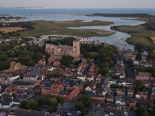 Free Stunning aerial photograph of Christchurch Priory and its surroundings at dusk. Stock Photo