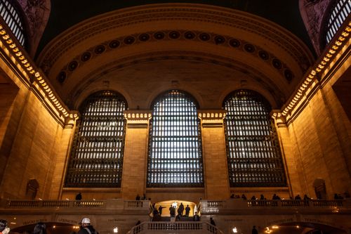 Free Grand Central Terminal's majestic interior showcasing its iconic arched windows and bustling atmosphere. Stock Photo