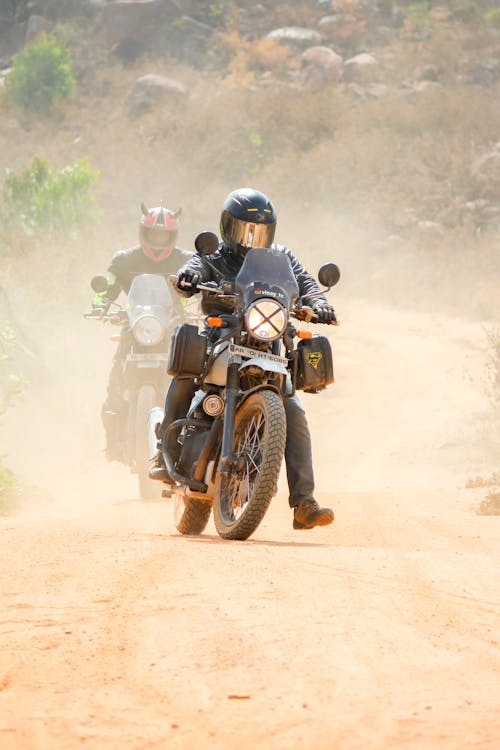 Free Man Riding Motorcycle On Dirt Road Stock Photo