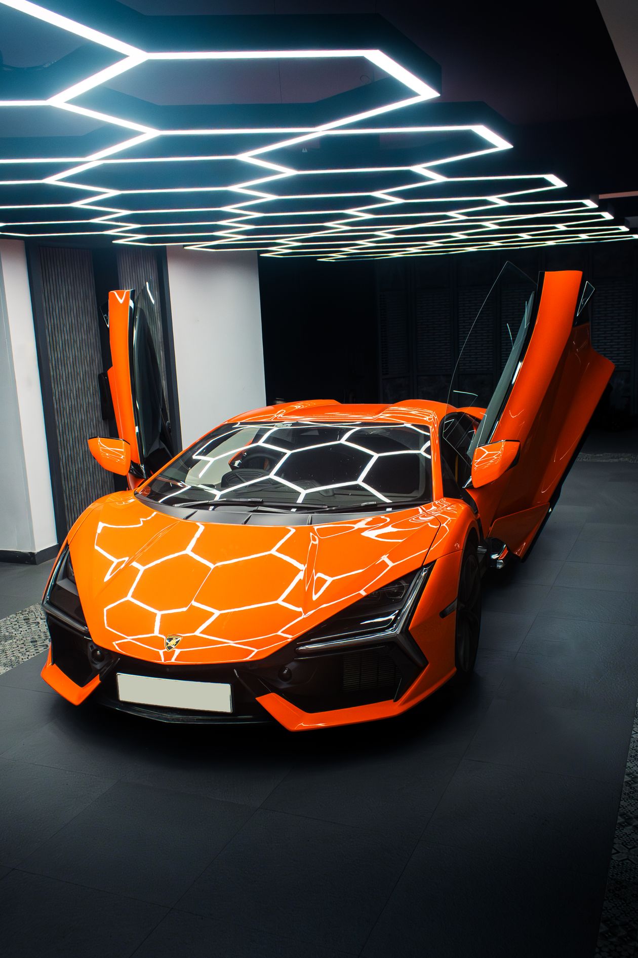 Orange supercar with doors open in a garage after supercar remapping UK work