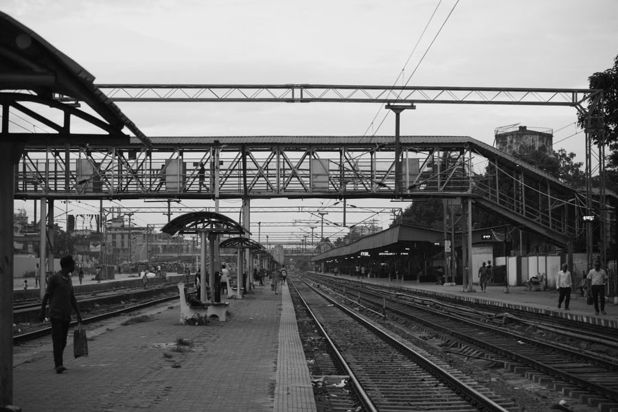 A black and white view of Dimapur Railway Station capturing the empty tracks and walkways.