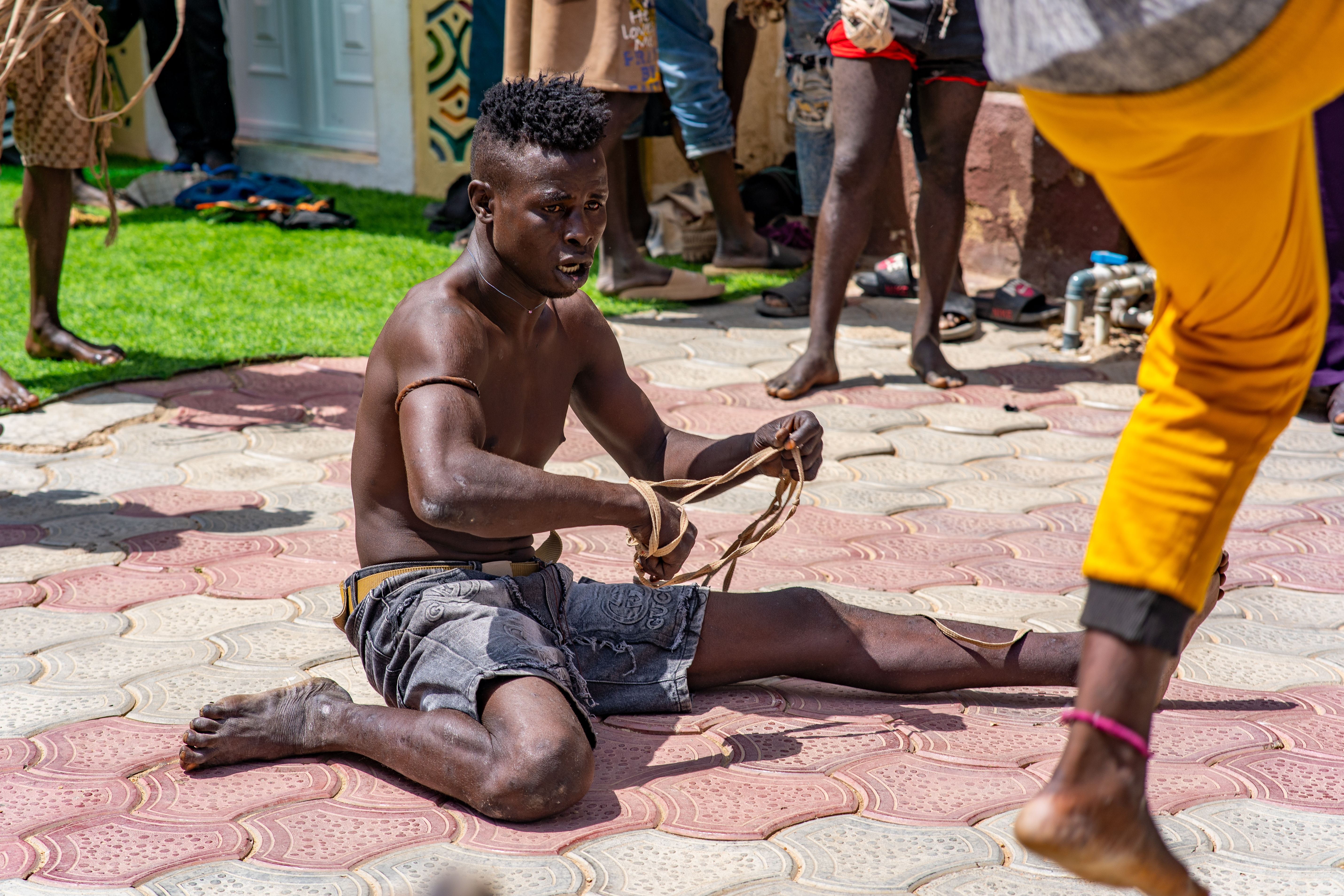 A young man performing traditional street art in Rano, Nigeria.