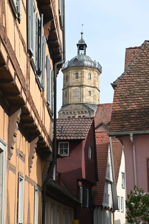 Free Charming German street view with traditional architecture and a prominent tower. Stock Photo
