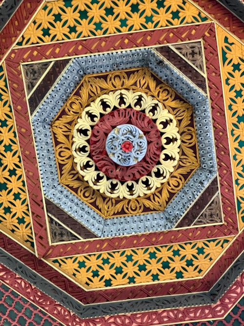 Free A vibrant, intricate geometric ceiling design with traditional patterns and vivid colors. Stock Photo