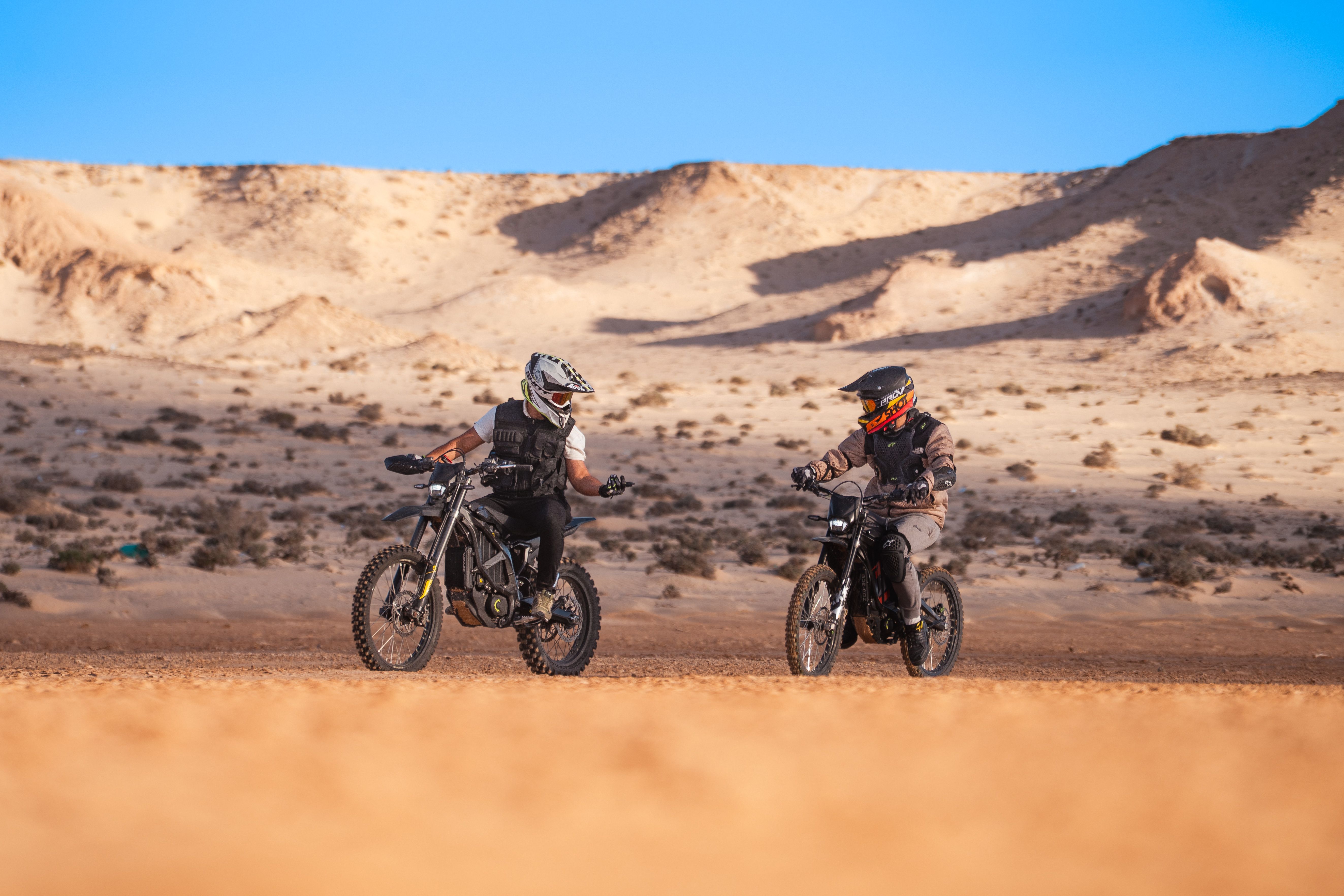 Two motorcyclists explore the sandy dunes of Oued Ed-Dahab, showcasing adventure and thrill.