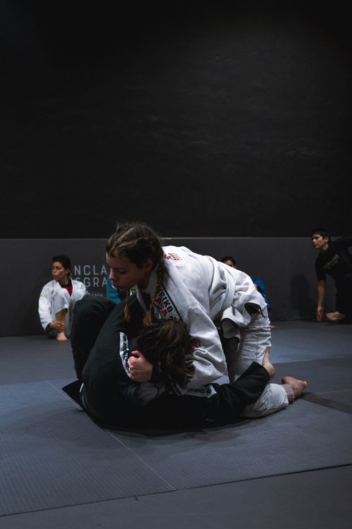 Free Two athletes sparring in a Brazilian Jiu-Jitsu training session, showcasing techniques. Stock Photo