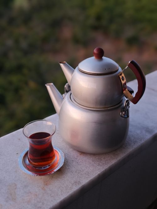 Free A traditional Turkish teapot and tea glass on a balcony with a scenic view. Stock Photo