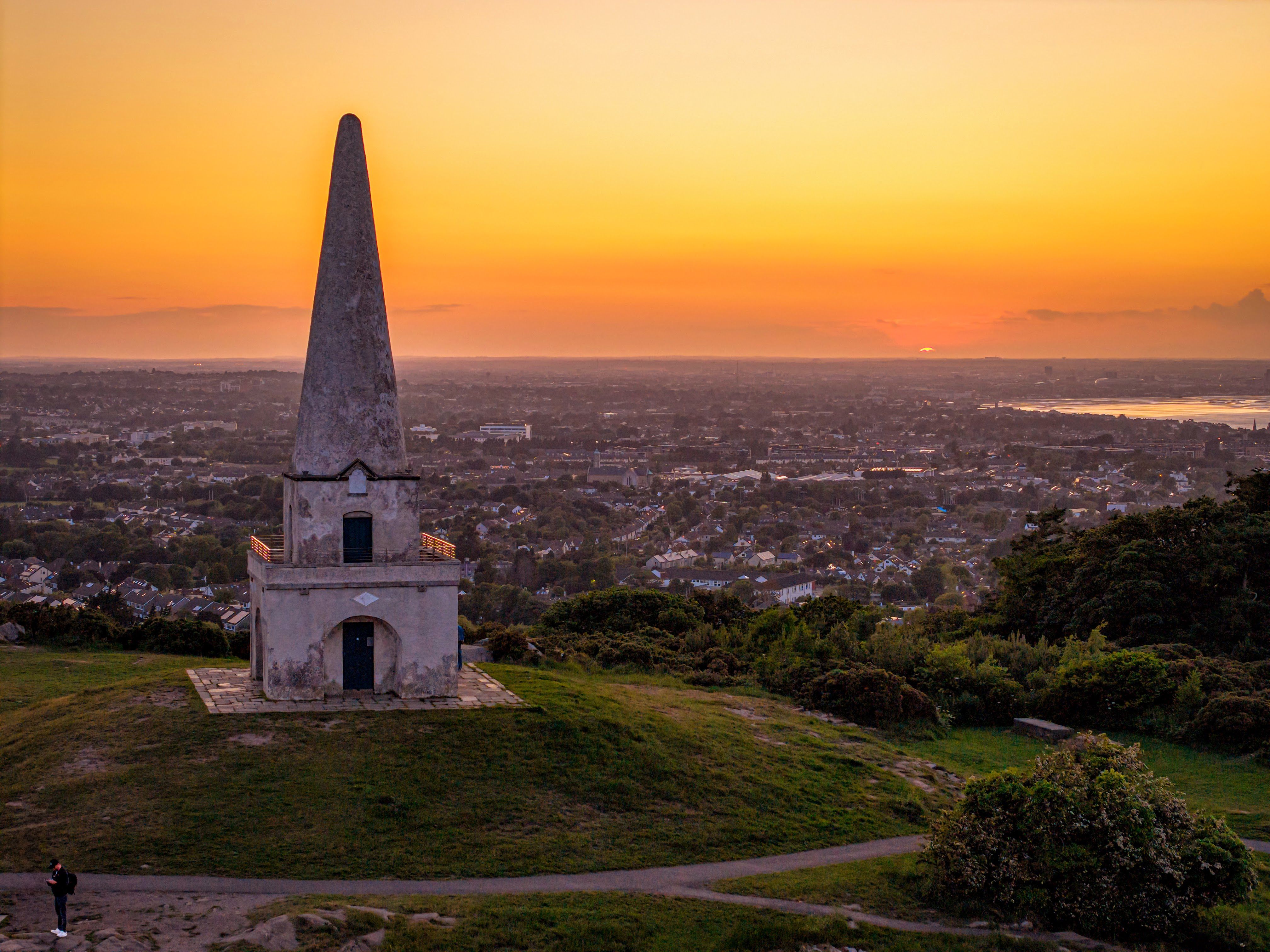 Captivating sunset over Killiney Hill Obelisk with a panoramic view of Dublin.