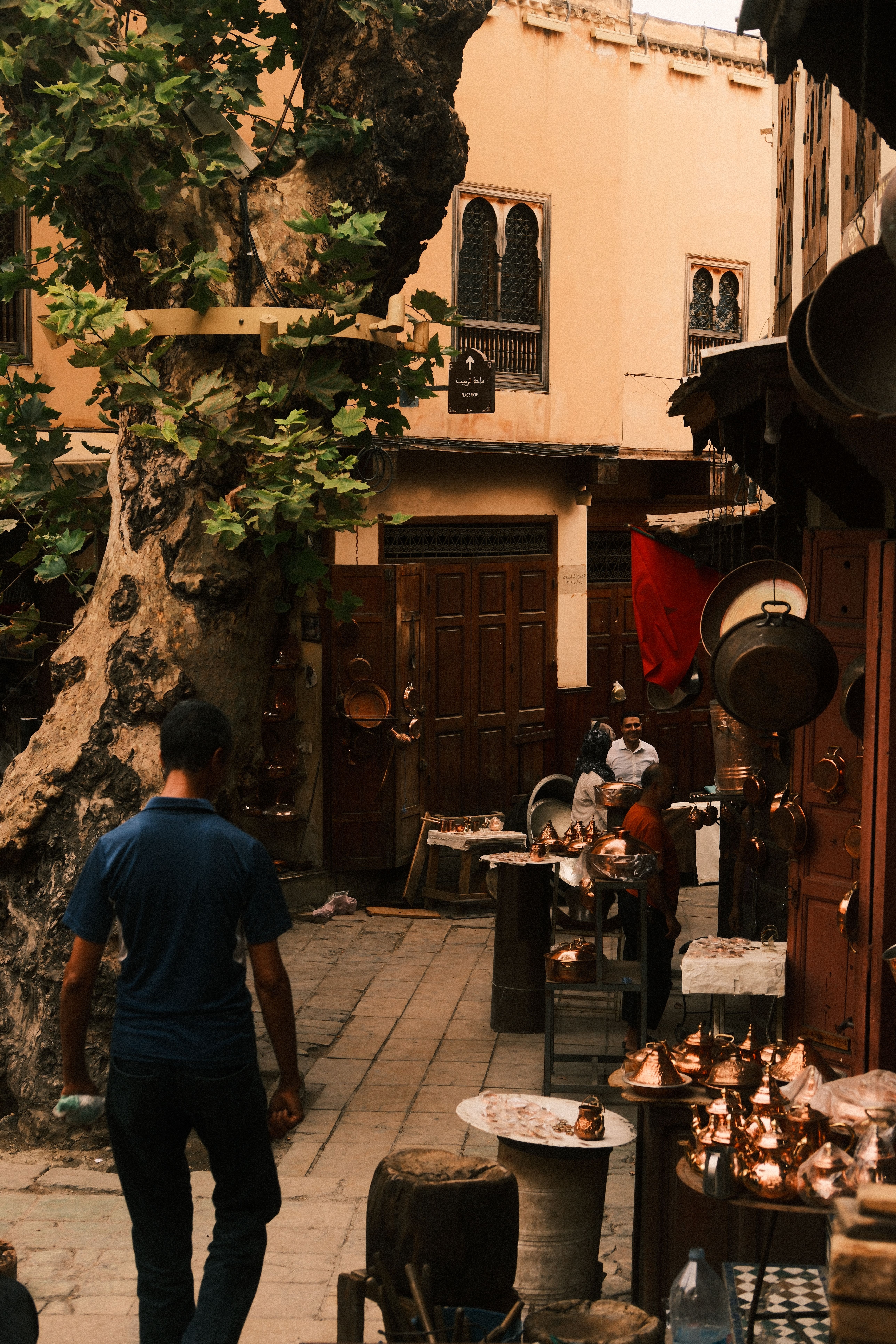 Lively street of Fes, Morocco with artisanal shops and people exploring the vibrant atmosphere.