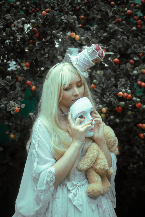 Free Dreamlike portrait featuring a masked person in an enchanted garden, Mexico City. Stock Photo