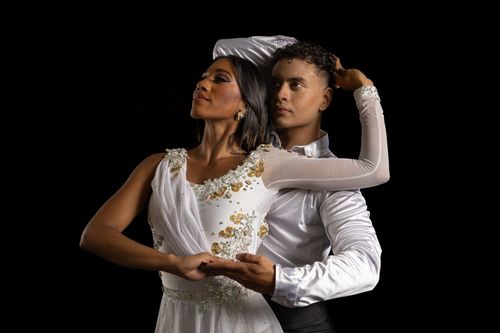 Free Captivating image of a dance couple in graceful poses against a black backdrop. Stock Photo