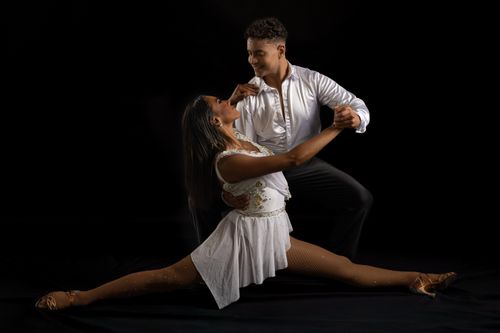 Free A couple performing a passionate dance pose in a studio setting with dramatic lighting. Stock Photo