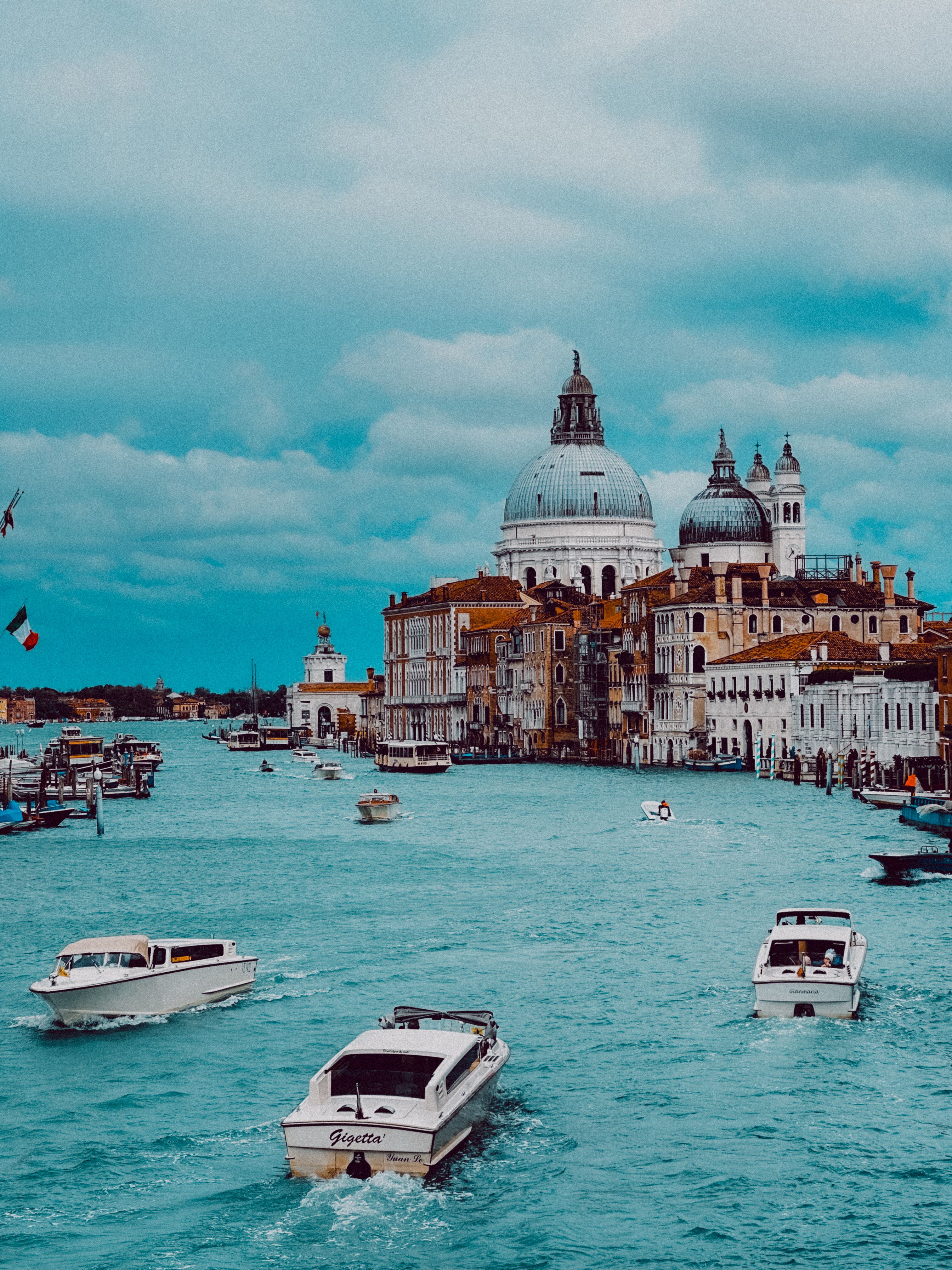 Charming view of Venice's Grand Canal with boats navigating past historic architecture.