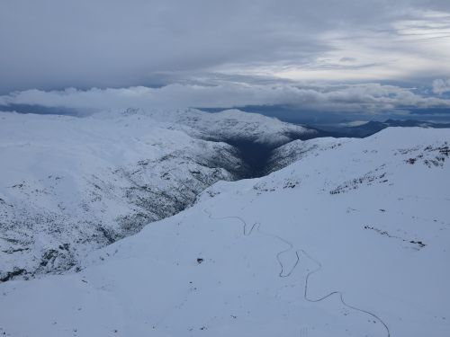 Free A breathtaking aerial view of the snow-covered Andes mountains under a cloudy sky. Stock Photo