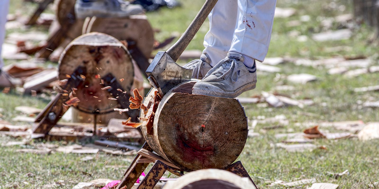 A person chopping wood with an axe outdoors