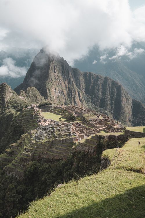 Free Experience the majestic beauty of Machu Picchu surrounded by clouds from Aguas Calientes, Peru. Stock Photo
