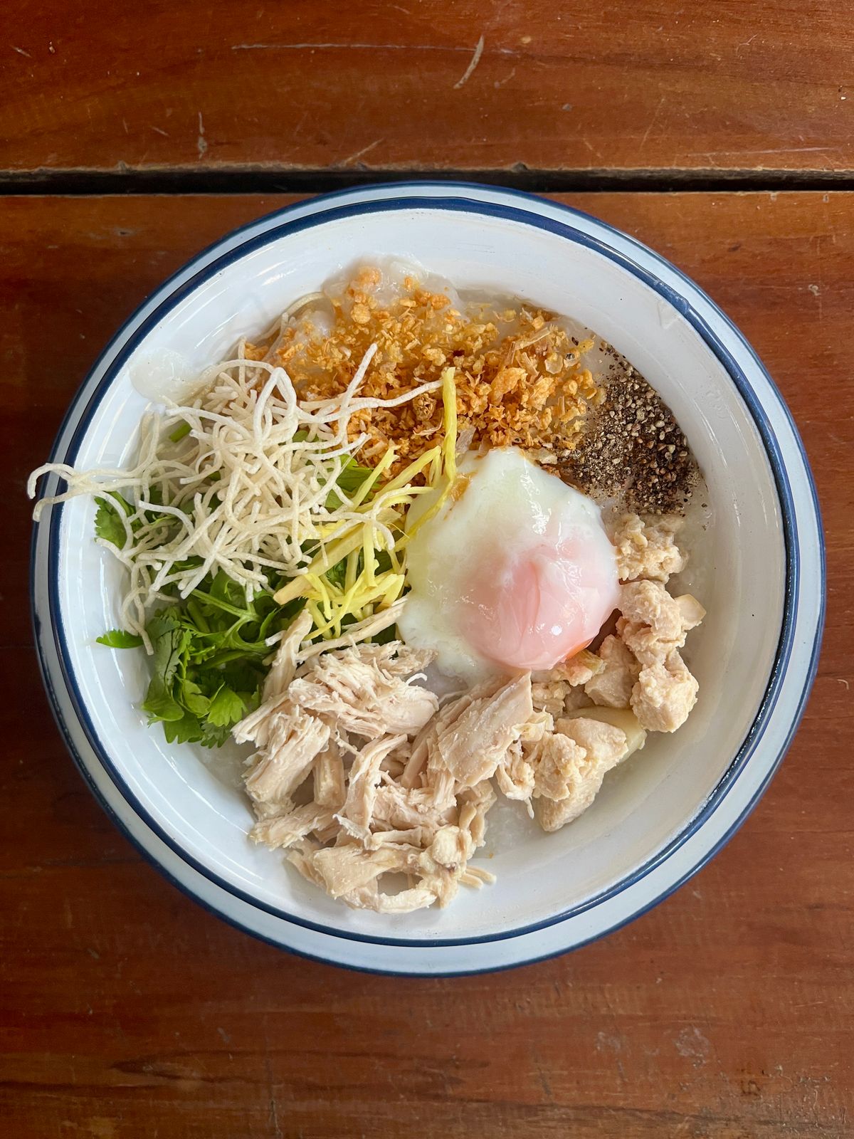 Shredded chicken jok with a soft-boiled egg, Thai style