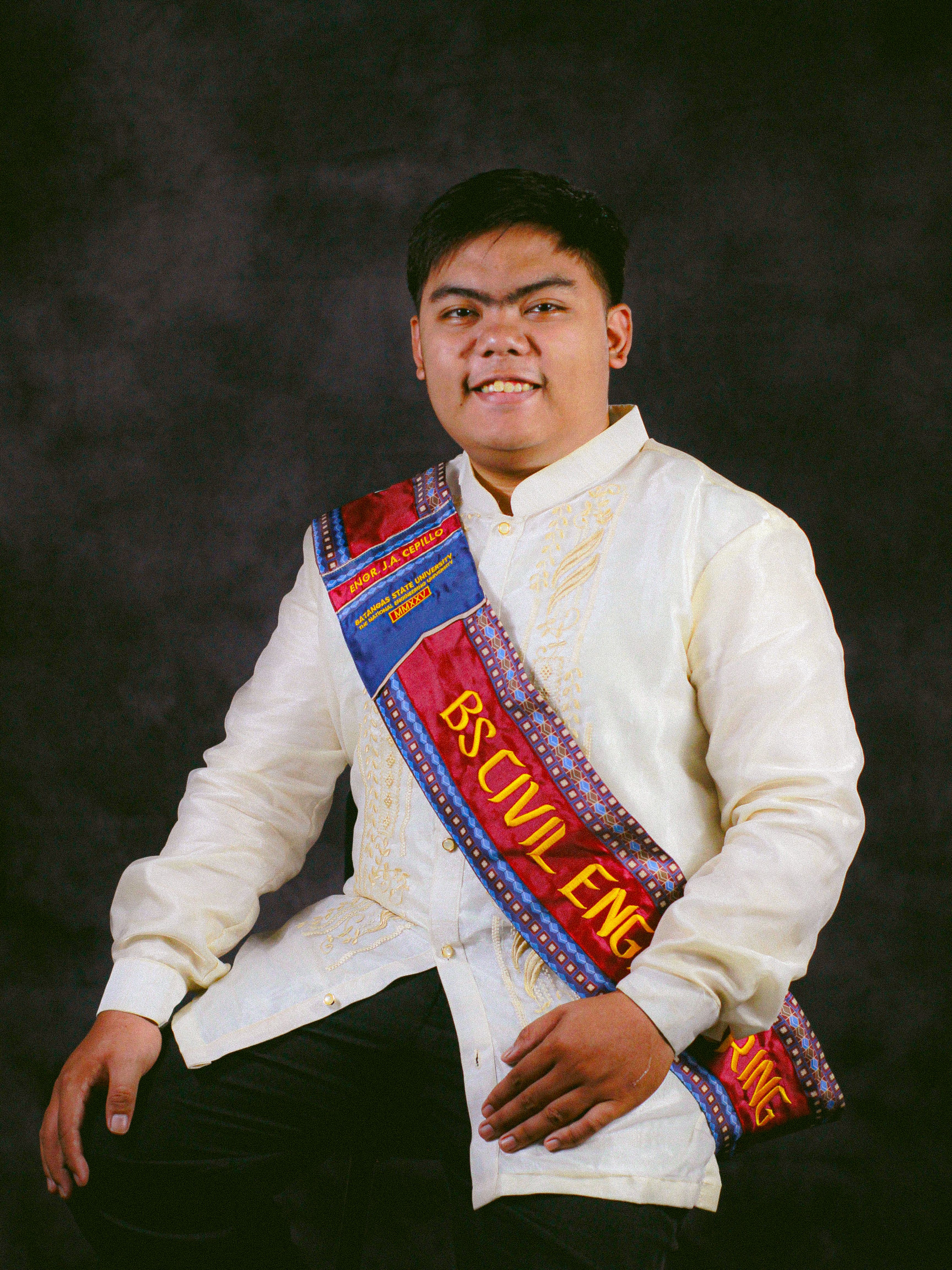 Proud graduate in traditional attire with a BS Civil Engineering sash.