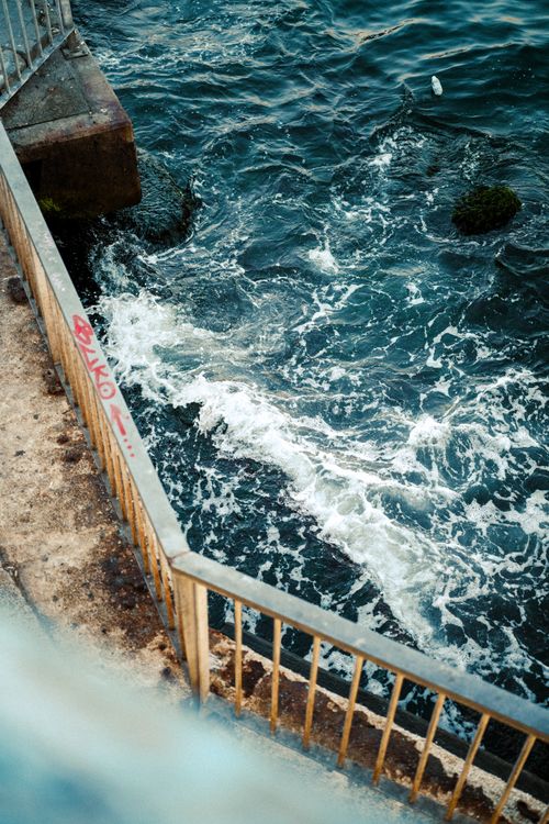Free View of waves crashing against a seawall in İstanbul, showcasing the dynamic interaction between water and urban infrastructure. Stock Photo