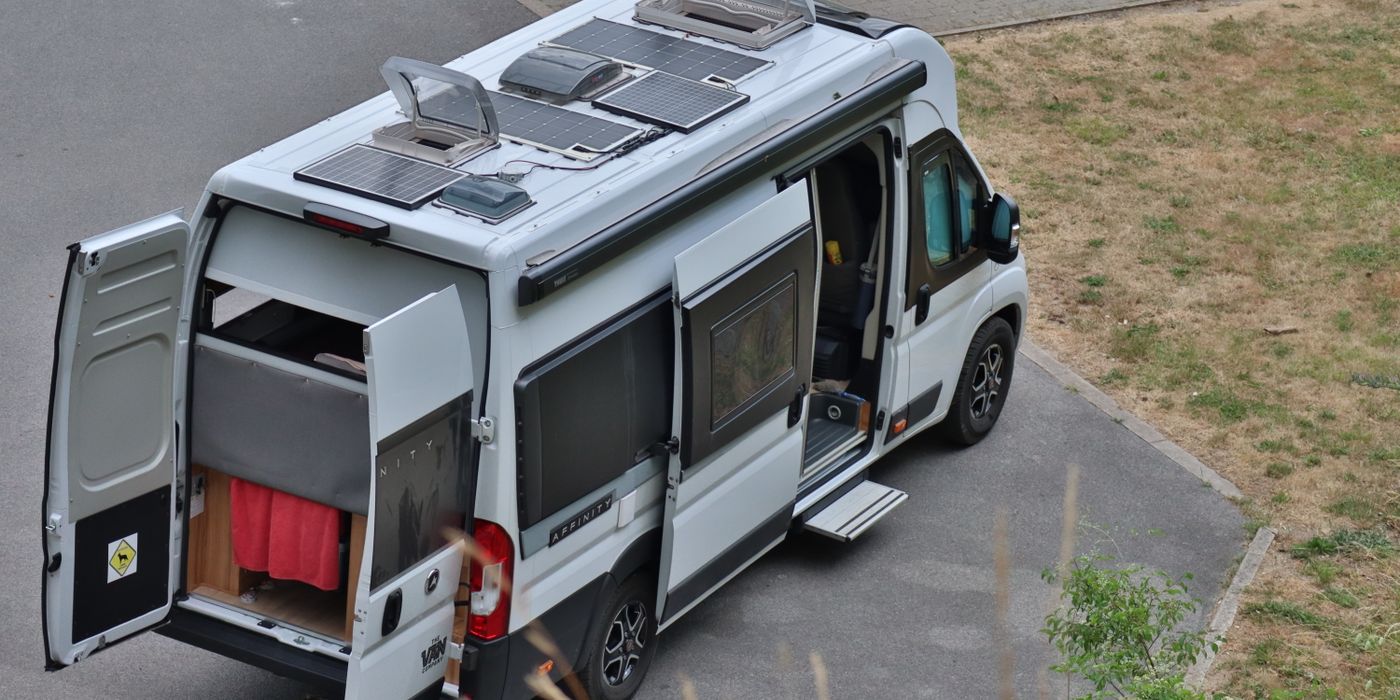 Looking down on a camper van roof with its vents and solar panels