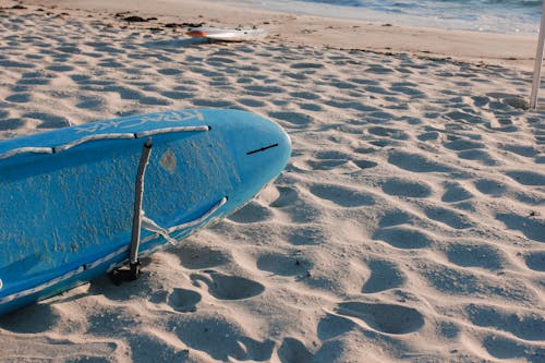 Blue Surfboard on the Sand