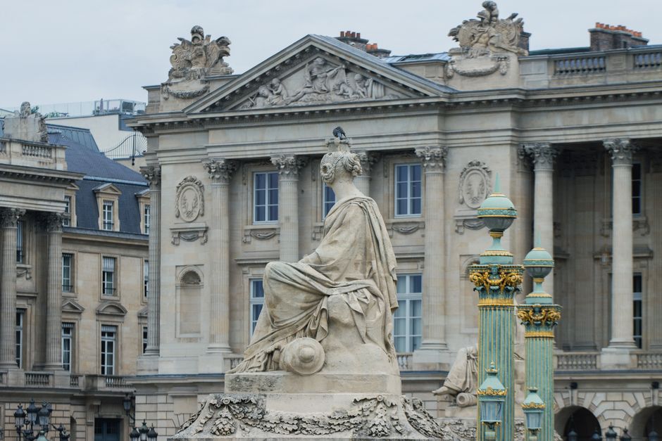 Detailed view of a classic statue in Place de la Concorde, Paris, showcasing neoclassical architecture.