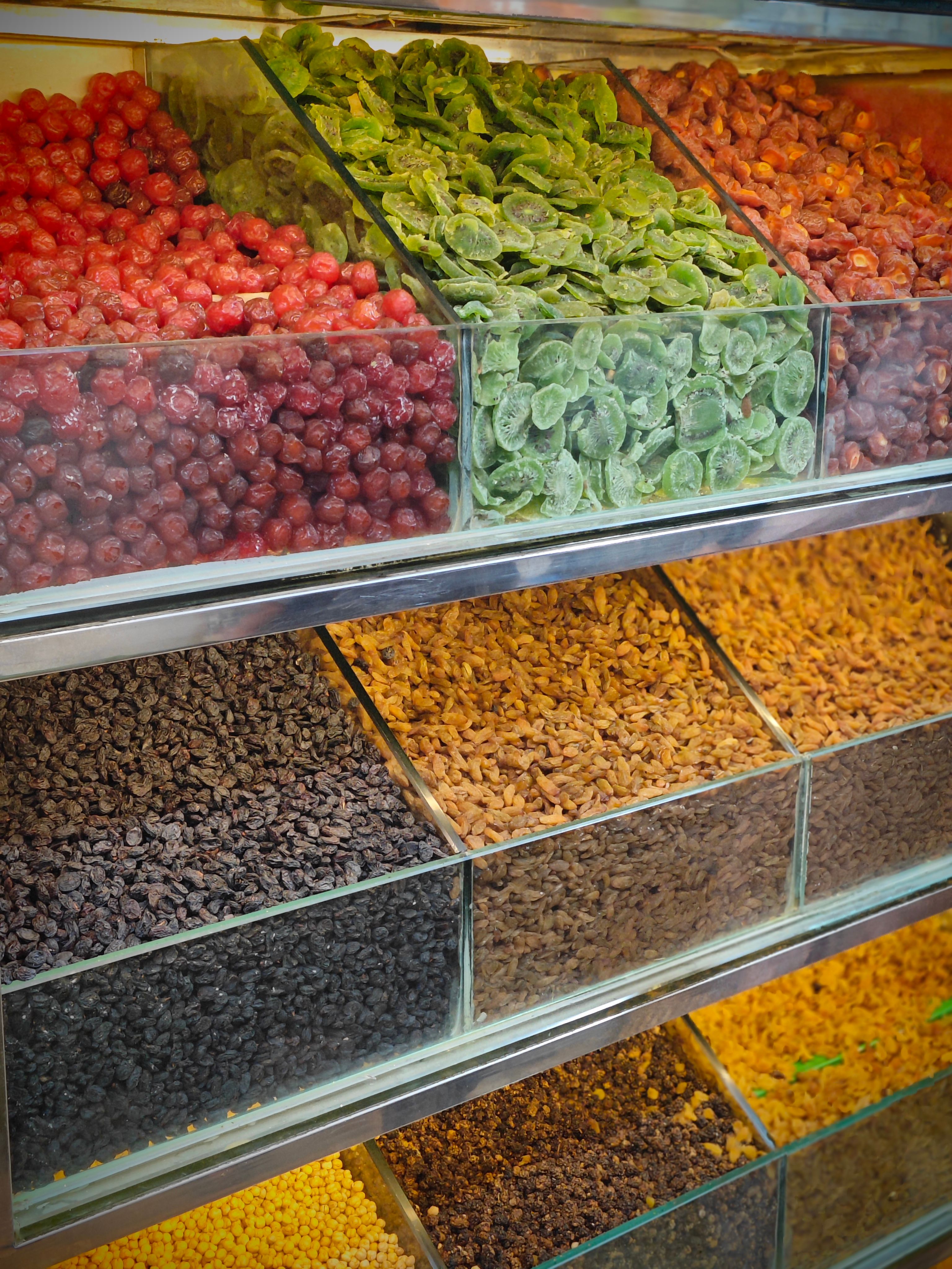 Vibrant selection of dried fruits and nuts in a market display case, perfect for culinary use. - New Section: Considerations for Buying Premium Quality Dry Fruits