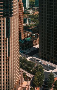 Aerial photo of a bustling urban cityscape featuring tall skyscrapers and streets below.