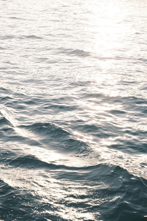 Free Beautiful sunlight reflecting on the waves of the Aegean Sea, capturing a serene and peaceful moment. Stock Photo