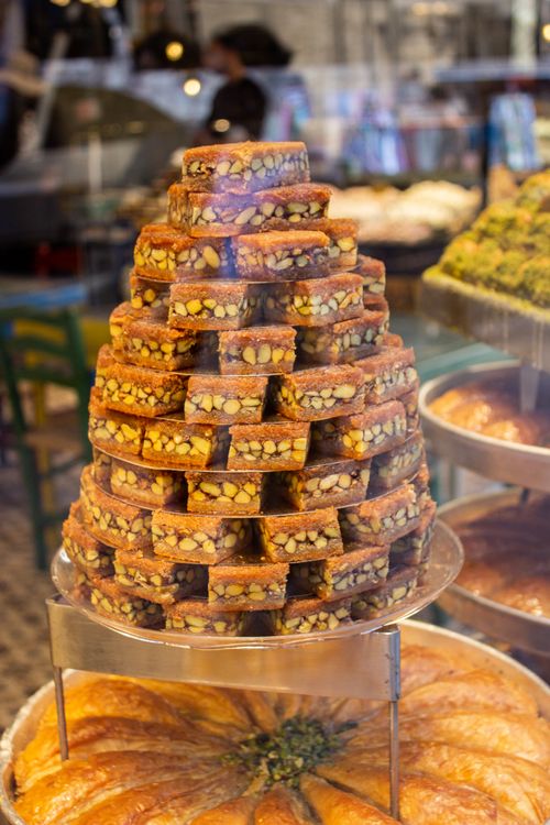 Free A vibrant display of traditional Turkish sweets stacked in a pyramid at a market in Istanbul. Stock Photo