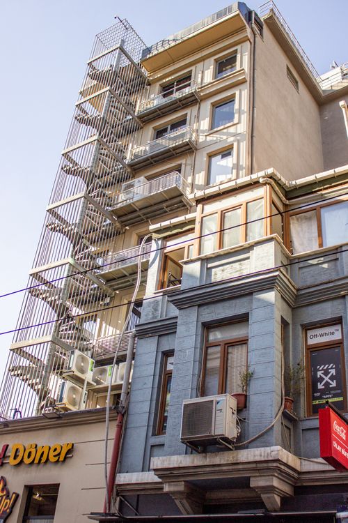 Free A tall urban building in Istanbul featuring a fire escape and colorful facades in daylight. Stock Photo