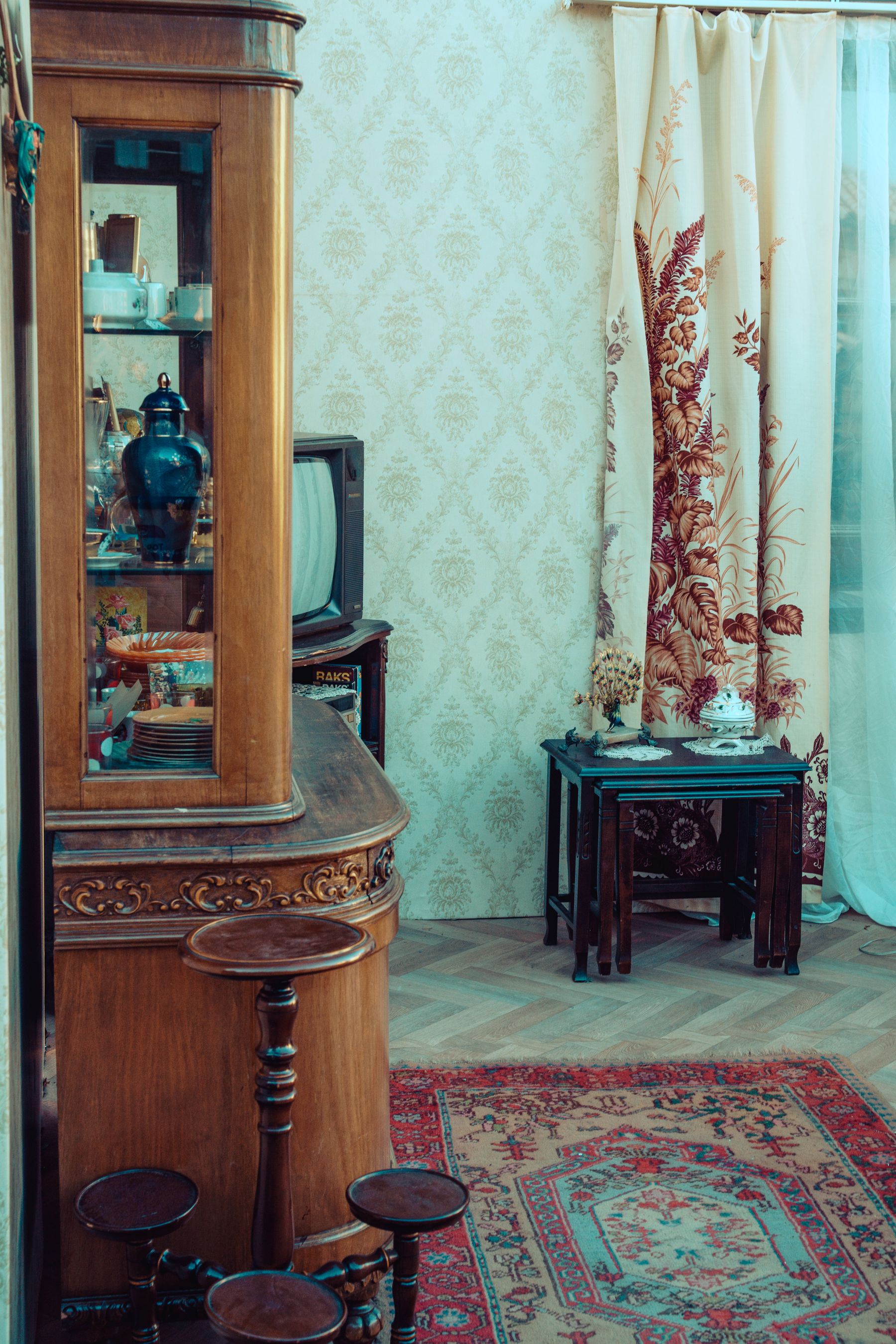 Collected living room with antique furniture, framed artwork and warm wood tones