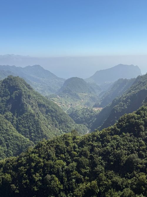 Free Stunning panoramic view of lush green mountains in Madeira, Portugal under a clear blue sky. Stock Photo